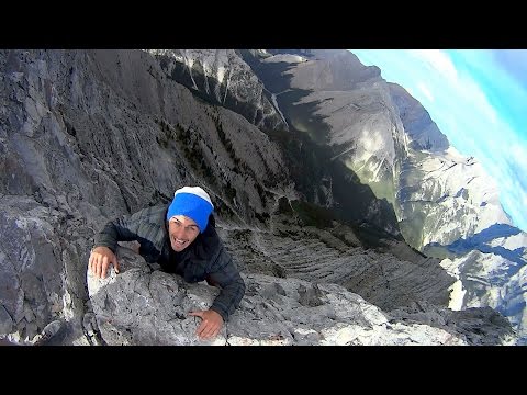 thrillseekers walk along treacherous mountain path