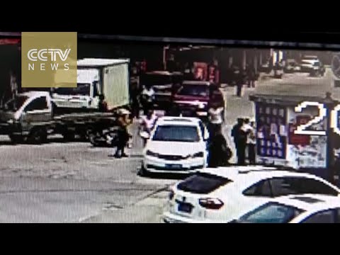 pedestrians lift car together to save woman