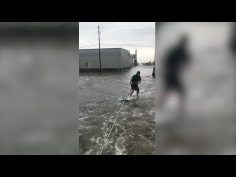 a man riding the floodwaters